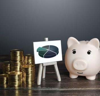 Wooden blocks with the word budget and a calculator with numbers 2022. Accumulating money and planning a budget. Business and finance. Loan, deposit, credit. Investments. Goals, income