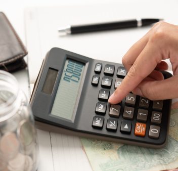 Woman calculating money coin for household saving. Save money in coin jar and do accounting during inflation crisis. Planning budget for home bill payment.